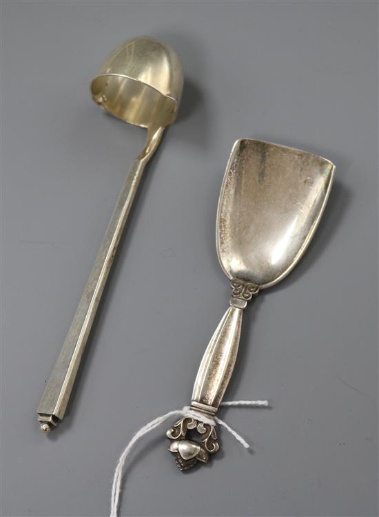 A 1930s Georg Jensen sterling silver cream ladle and a Georg Jensen silver caddy spoon.
